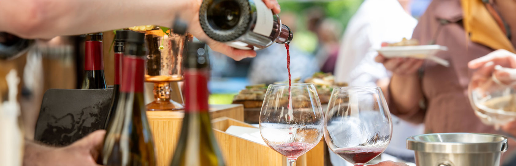 Wine pouring into glass at winery party